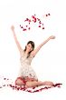 young girl tossing rose petal