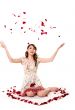 young girl tossing rose petal