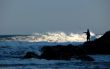 fisherman silhouette on rocks