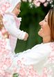 happy mother with baby and flowers