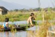 two young girls in wooden canoe