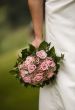 Bride holding bouquet of roses