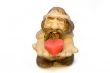 FIGURE of the old man from a stone holding in hands red heart