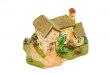 Stone model of a country small house with a garden
