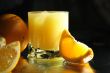 Full glass of orange juice with ice