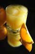Glass of orange juice on dark
