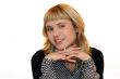 young woman is smiling in office