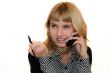 young woman with mobike phone is smiling in office