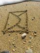 envelope on wet sea sand