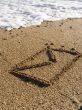 envelope on wet sea sand
