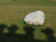 Lonely White Stone over Green Grass Garden