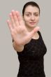 Stop. woman on a grey background.