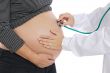 Pregnant examined by a doctor