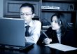 business partners on a laptop in an office