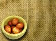 Woven basket with colorful easter eggs on canvas