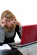 woman is thinking and calling by phone sitting near laptop