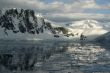 Twilight: Icy mountains reflected on calm seas
