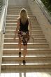 Blonde girl walking on stairs