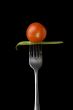 Cherry tomato and peas on fork