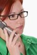 Redheaded girl talking on a mobile phone