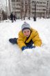 The boy rolls snow whom