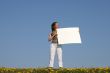 Girl holding blank banner with copy space