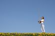 Girl playing berimbau in spring meadow