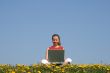 Casual young woman with laptop outdoors
