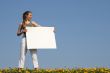 Nice girl holding blank white cardboard