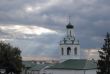 Sun beams through clouds over church