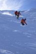 Multiple exposure: Red skier in powder snow