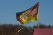 German flag on a background of the sky.