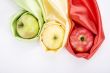 three apples of different colour wrapped in silk