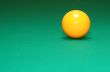 shot of pool table and yellow ball