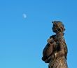 women sculpture looking at the moon