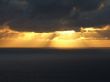 Rays of sun passing trough clouds at sea side