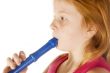 young girl is playing on a  flute