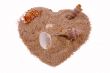 Heart from sand with cockleshells on white.