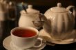 cup of tea and teaport on table in cafe