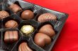 Valentines chocolates in box on red silk
