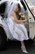 Bride exiting wedding car limousine