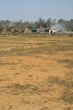 open field with view on stone industry,  india