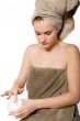 Young woman appying some creme
