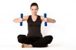 Young girl is concentrating on weights