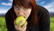 Girl eating delicious green apple