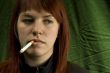 Girl smoking cigarette and bored