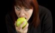 Girl eating delicious green apple