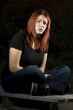 Pensive girl sitting on wood