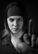 Girl ignoring a middle finger gesture and aggresively staring ba