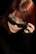 Girl looking through sunglasses.